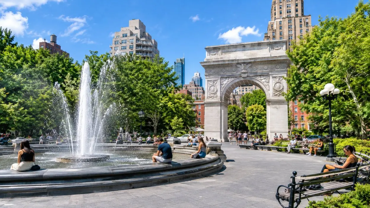 Washington Square Park with the arch, the fountain and people on the benches